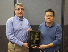 Jim and Hongmin holding US Patent plaque